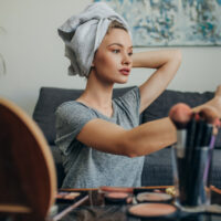 Young woman in her apartment creating a make up selfie